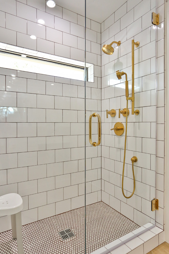 Inspiration for a large 1960s 3/4 white tile and subway tile light wood floor and beige floor alcove shower remodel in Austin with flat-panel cabinets, white cabinets, white walls, an undermount sink, granite countertops, a hinged shower door and multicolored countertops