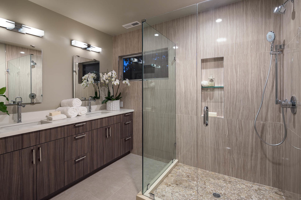 Mid-sized trendy master multicolored tile and porcelain tile porcelain tile double shower photo in Los Angeles with flat-panel cabinets, black cabinets, a one-piece toilet, beige walls, an undermount sink and quartz countertops