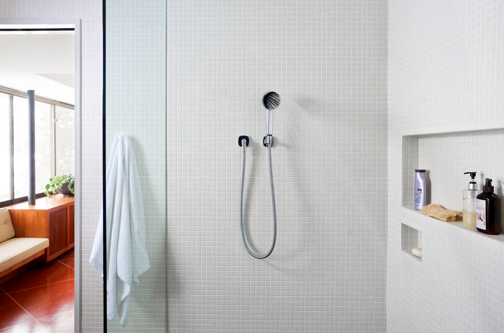 Example of a mid-sized trendy master gray tile terra-cotta tile doorless shower design in New York with an undermount sink, furniture-like cabinets, gray walls, medium tone wood cabinets and wood countertops