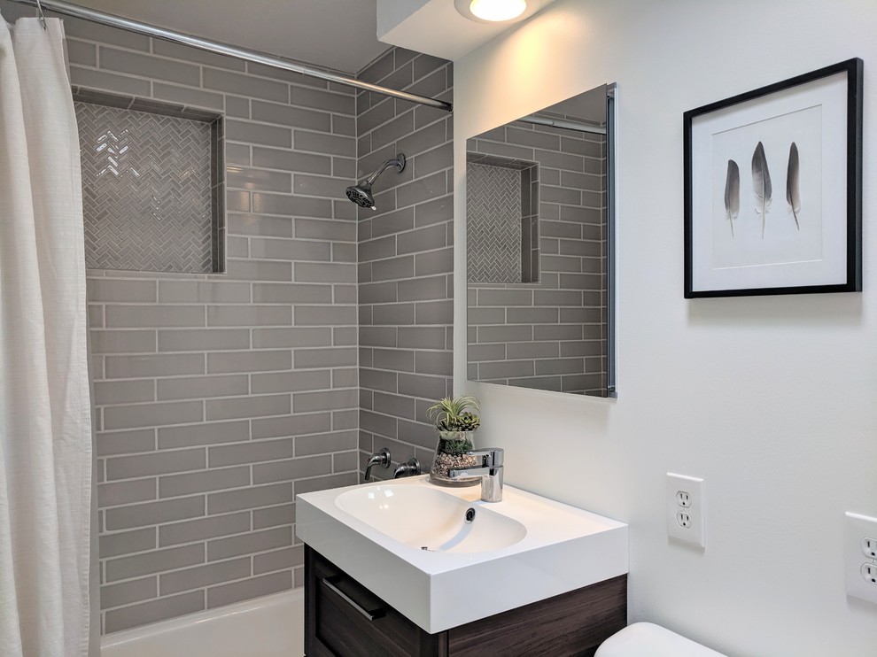 Example of a small 1950s 3/4 gray tile and subway tile mosaic tile floor and multicolored floor bathroom design in Other with flat-panel cabinets, dark wood cabinets, white walls, a drop-in sink and white countertops