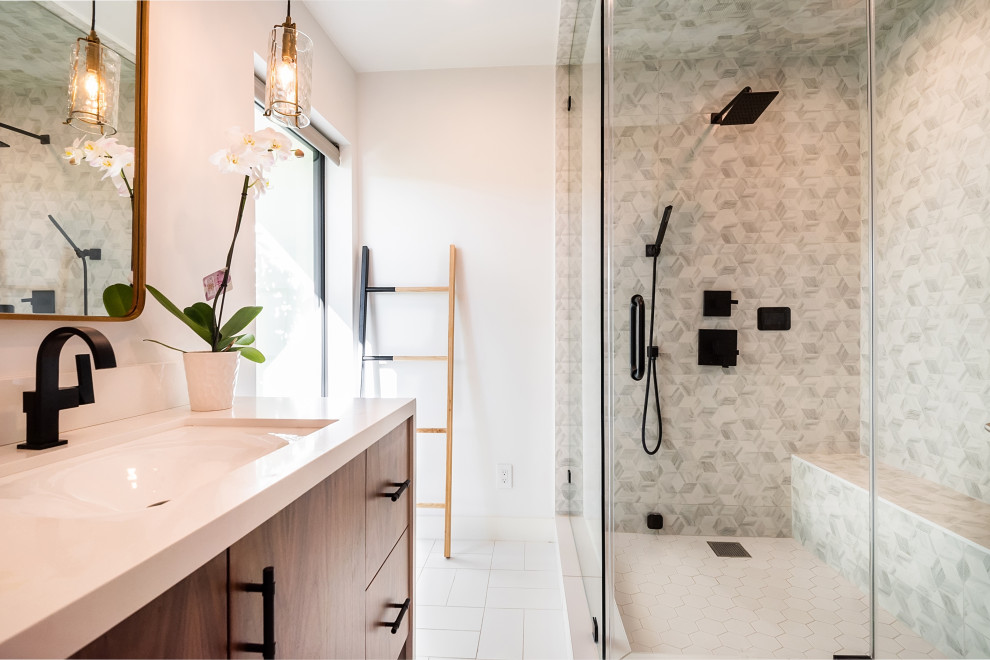 Example of a mid-sized transitional master gray tile and ceramic tile ceramic tile, white floor and single-sink bathroom design in Los Angeles with flat-panel cabinets, medium tone wood cabinets, an undermount sink, marble countertops, a hinged shower door, white countertops and a built-in vanity