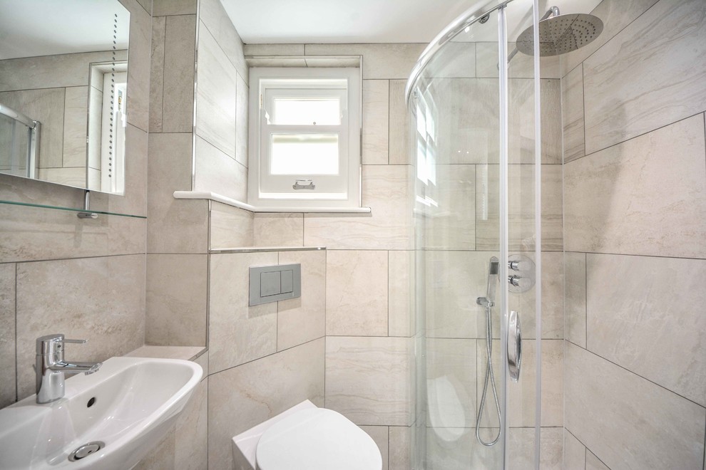 Photo of a small contemporary family bathroom in Kent with a built-in sink, tiled worktops, a corner shower, a wall mounted toilet, beige tiles, porcelain tiles, beige walls and ceramic flooring.