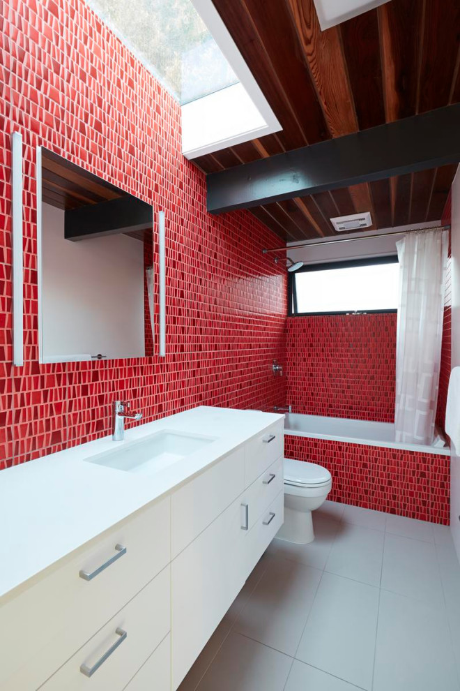 Photo of a large midcentury shower room bathroom in San Francisco with flat-panel cabinets, white cabinets, a built-in bath, a shower/bath combination, red tiles, a submerged sink, grey floors, a shower curtain, white worktops, a single sink, a floating vanity unit and a wood ceiling.