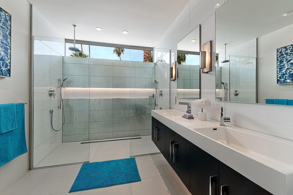 This is an example of a retro shower room bathroom in Los Angeles with a trough sink, flat-panel cabinets, dark wood cabinets, a double shower, white tiles and white walls.