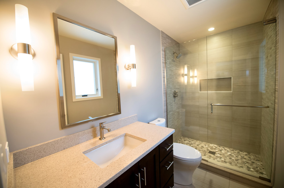 Design ideas for a retro bathroom in Chicago with a submerged sink, shaker cabinets, dark wood cabinets, engineered stone worktops, an alcove shower, grey tiles, porcelain tiles, grey walls and limestone flooring.