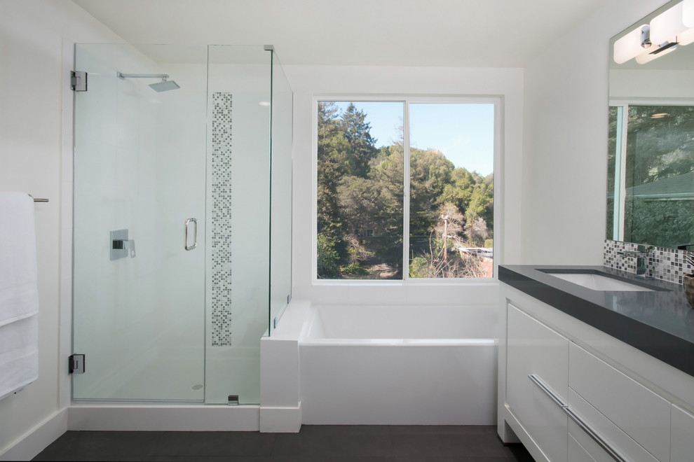 Inspiration for a large midcentury ensuite bathroom in San Francisco with flat-panel cabinets, white cabinets, a built-in bath, a corner shower, a one-piece toilet, white tiles, porcelain tiles, white walls, dark hardwood flooring, a submerged sink, engineered stone worktops, brown floors, a hinged door and grey worktops.