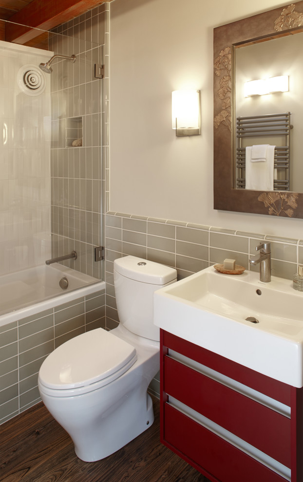Small midcentury bathroom in San Francisco with red cabinets, an alcove bath, a shower/bath combination, green tiles, ceramic tiles, green walls and dark hardwood flooring.