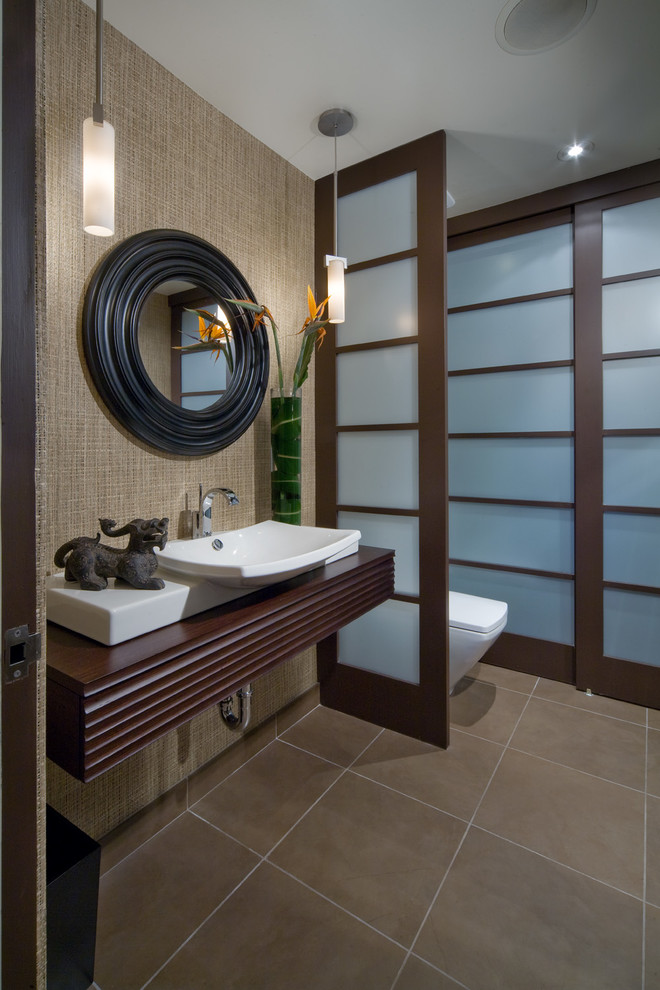 Inspiration for a small 1960s 3/4 brown tile and porcelain tile alcove shower remodel in Orlando with a vessel sink, dark wood cabinets, wood countertops, a one-piece toilet, brown walls and brown countertops