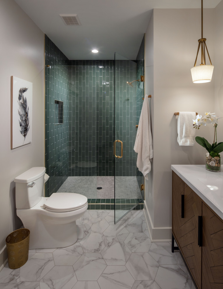 This is an example of a medium sized classic bathroom in Atlanta with freestanding cabinets, brown cabinets, a built-in shower, a one-piece toilet, green tiles, porcelain tiles, grey walls, porcelain flooring, a submerged sink, marble worktops, grey floors, a hinged door, white worktops, a single sink and a freestanding vanity unit.