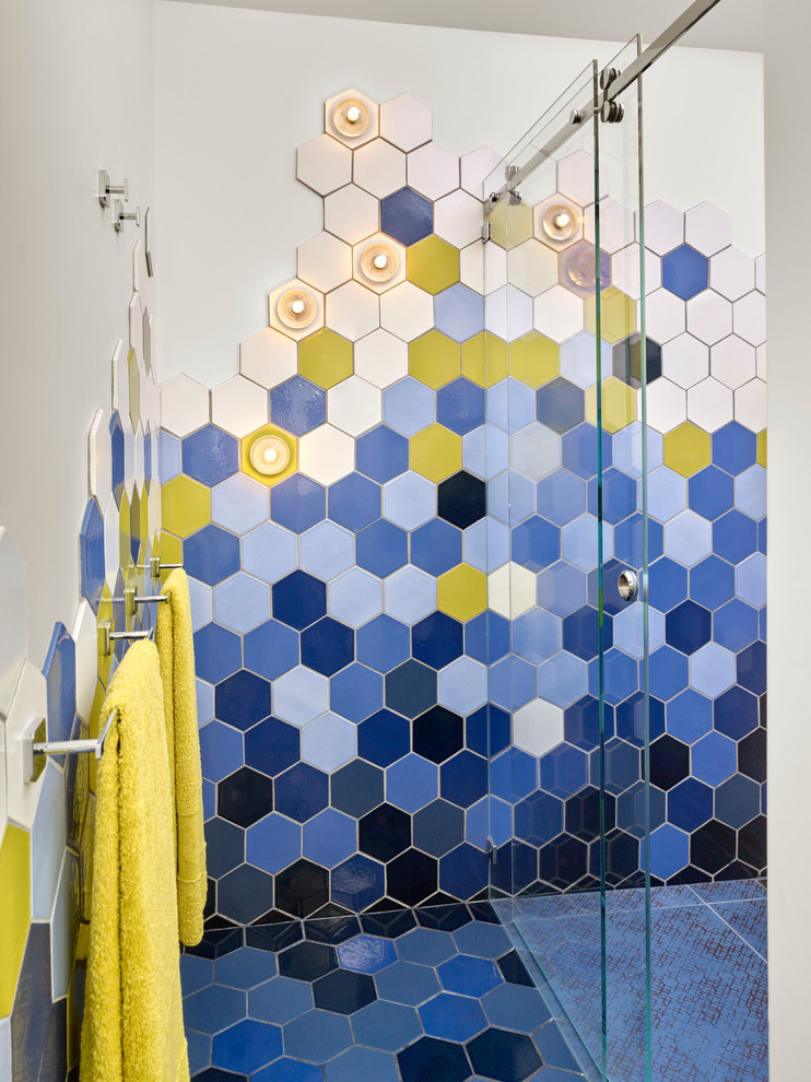 Inspiration for a medium sized modern family bathroom in San Francisco with blue tiles, a built-in shower, ceramic tiles, blue walls, ceramic flooring, flat-panel cabinets, dark wood cabinets, a wall mounted toilet, a submerged sink and engineered stone worktops.