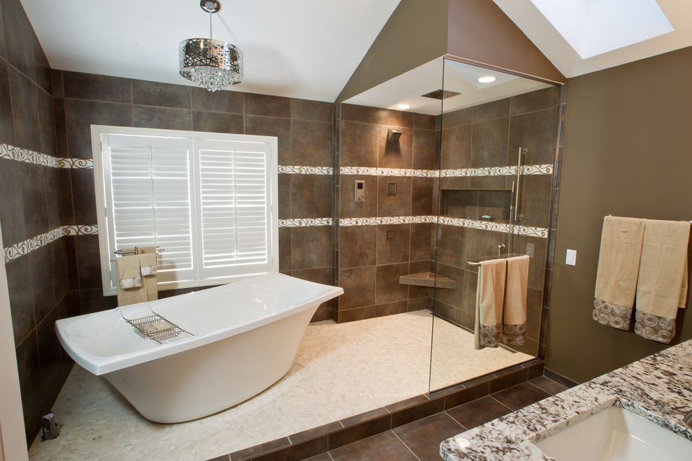 Design ideas for a medium sized traditional ensuite bathroom in Other with a submerged sink, flat-panel cabinets, medium wood cabinets, granite worktops, a freestanding bath, a corner shower, a one-piece toilet, brown tiles, stone tiles, brown walls, porcelain flooring and brown floors.
