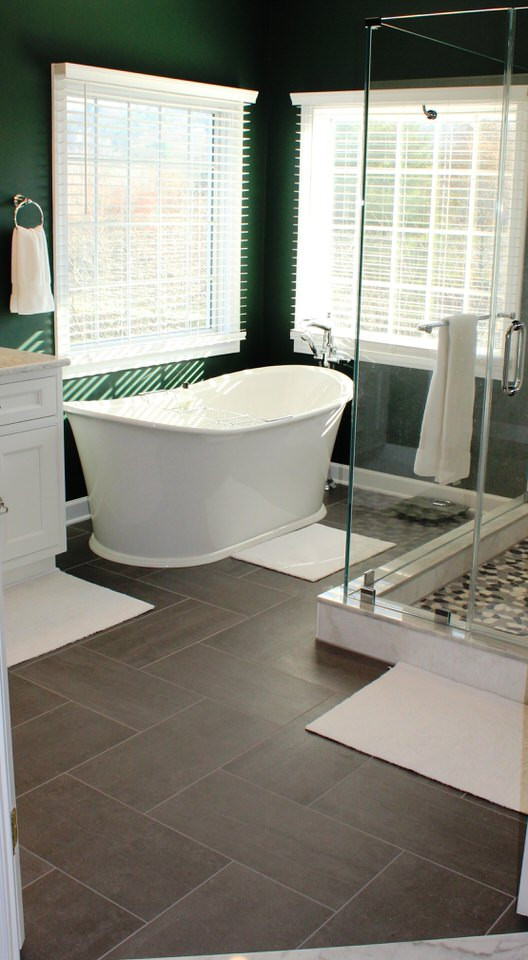 Exemple d'une grande salle de bain principale chic avec des portes de placard blanches, une baignoire indépendante, une douche d'angle, des carreaux de céramique, un mur vert, carreaux de ciment au sol, un sol gris et une cabine de douche à porte battante.
