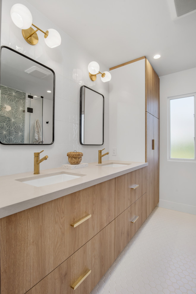 Photo of a large nautical shower room bathroom in Orange County with beaded cabinets, light wood cabinets, a corner shower, a one-piece toilet, white tiles, white walls, porcelain flooring, a submerged sink, quartz worktops, white floors, a hinged door, white worktops, double sinks, a built in vanity unit, ceramic tiles and a shower bench.