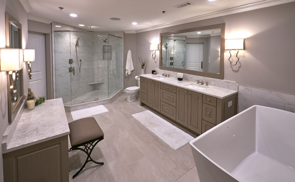 Mid-sized elegant master gray tile and marble tile beige floor and light wood floor bathroom photo in Atlanta with shaker cabinets, light wood cabinets, gray walls, a drop-in sink, marble countertops, gray countertops and a hinged shower door