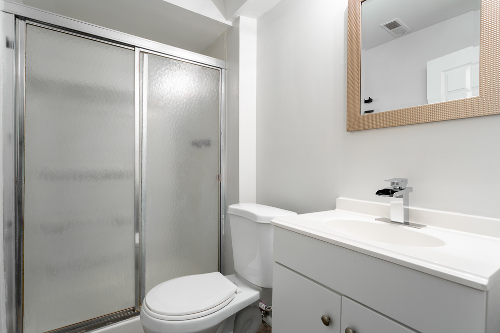 Design ideas for a small modern shower room bathroom in Salt Lake City with shaker cabinets, white cabinets, an alcove shower, a two-piece toilet, grey walls, an integrated sink, solid surface worktops, a sliding door and white worktops.