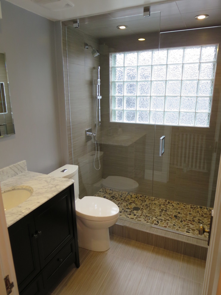 Inspiration for a small modern 3/4 beige tile and porcelain tile pebble tile floor and multicolored floor alcove shower remodel in Toronto with recessed-panel cabinets, black cabinets, a two-piece toilet, beige walls, an undermount sink, granite countertops and a hinged shower door