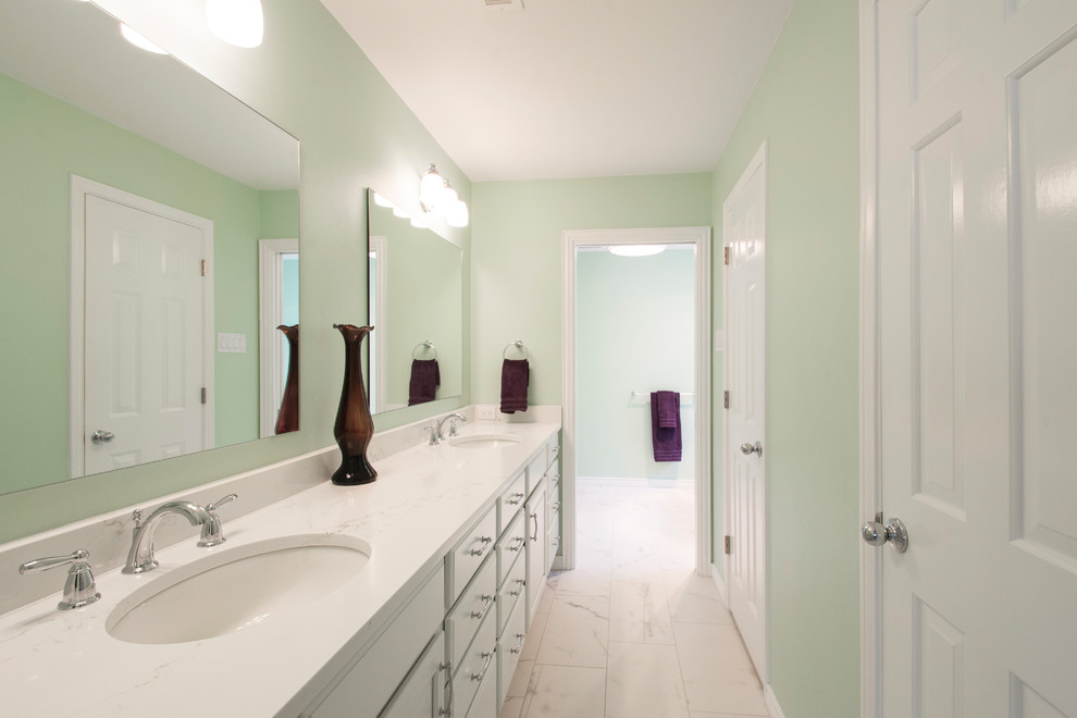 Inspiration for a medium sized traditional ensuite bathroom in Dallas with raised-panel cabinets, white cabinets, a freestanding bath, a corner shower, a two-piece toilet, white tiles, marble tiles, green walls, porcelain flooring, a submerged sink, engineered stone worktops, white floors and a hinged door.