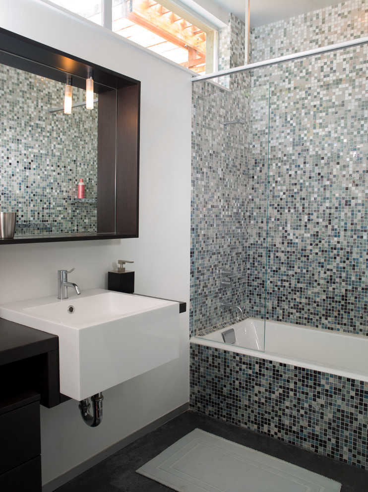 Modern half tiled bathroom in San Francisco with a wall-mounted sink.