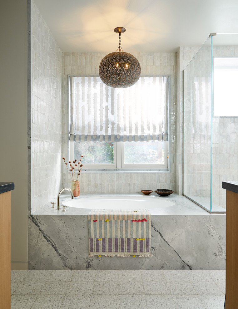 Scandinavian bathroom in San Francisco with flat-panel cabinets, light wood cabinets, a built-in bath, white tiles, white walls, ceramic flooring, a built-in sink, white floors, a hinged door and grey worktops.