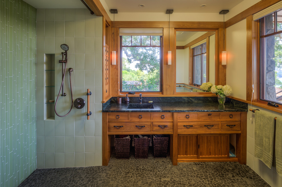 Aménagement d'une grande salle de bain craftsman en bois brun avec un lavabo intégré, un plan de toilette en marbre, une douche ouverte, un carrelage vert, un carrelage en pâte de verre, un mur beige et aucune cabine.