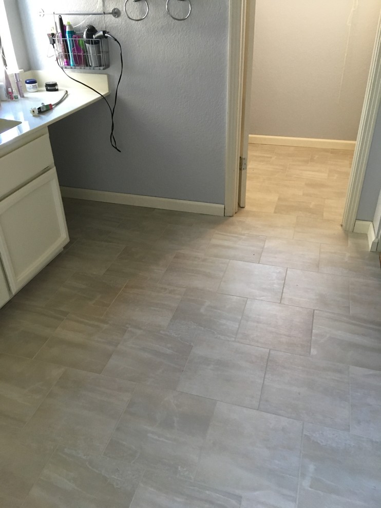 Example of a mid-sized classic master beige tile ceramic tile and beige floor bathroom design in Sacramento with recessed-panel cabinets, white cabinets, gray walls, an undermount sink and solid surface countertops