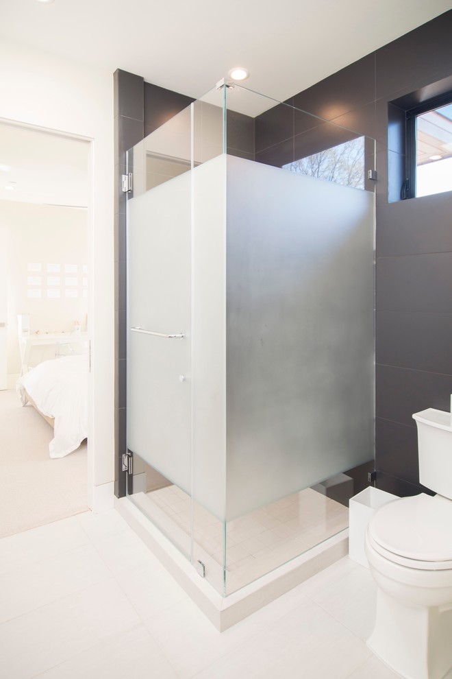 Example of a mid-sized trendy master gray tile porcelain tile and white floor corner shower design in San Francisco with flat-panel cabinets, dark wood cabinets, a one-piece toilet, white walls, an undermount sink, quartzite countertops and a hinged shower door