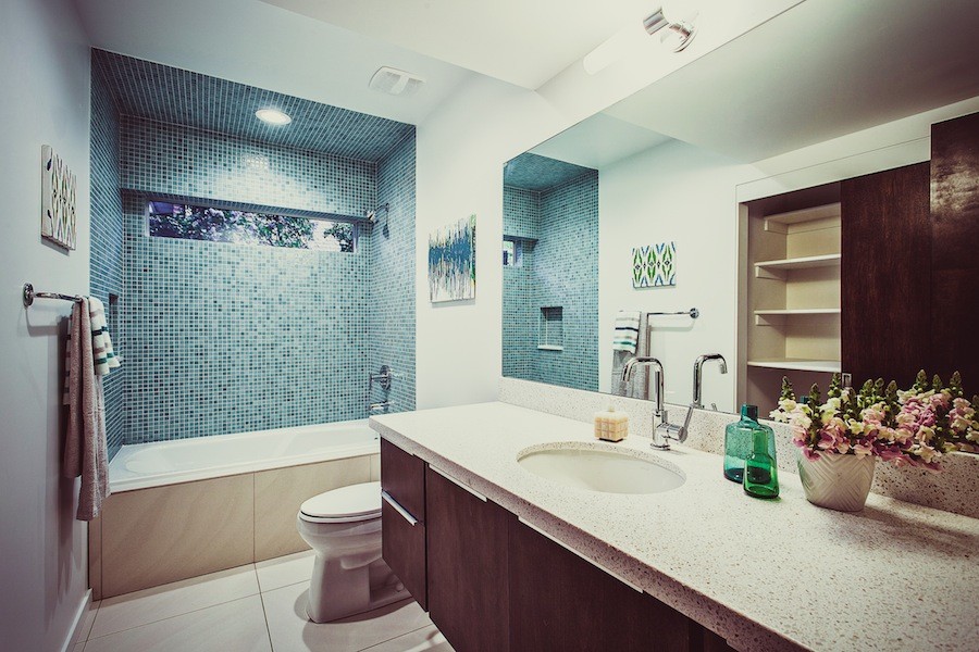 This is an example of a midcentury ensuite bathroom in Salt Lake City with flat-panel cabinets, dark wood cabinets, a walk-in shower, blue tiles, mosaic tiles, a hinged door, a shower bench, double sinks, a floating vanity unit and a wood ceiling.