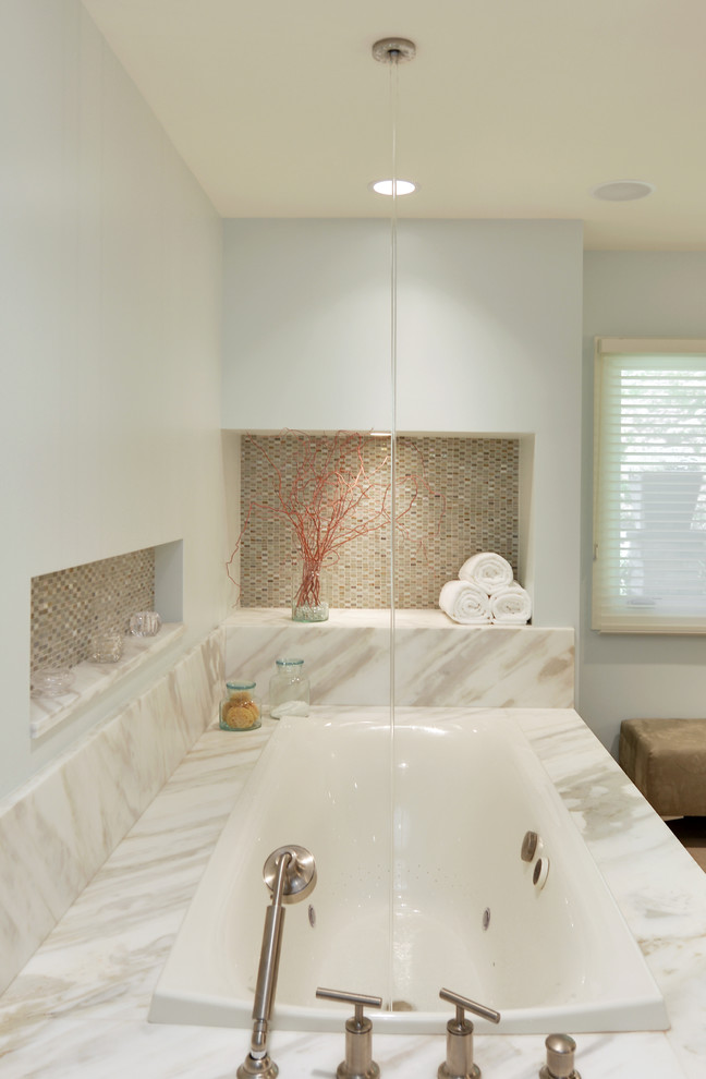 Inspiration for an expansive contemporary ensuite bathroom in Milwaukee with flat-panel cabinets, medium wood cabinets, wooden worktops, a corner bath, an alcove shower, beige walls, an integrated sink, a hinged door, multi-coloured worktops and beige floors.