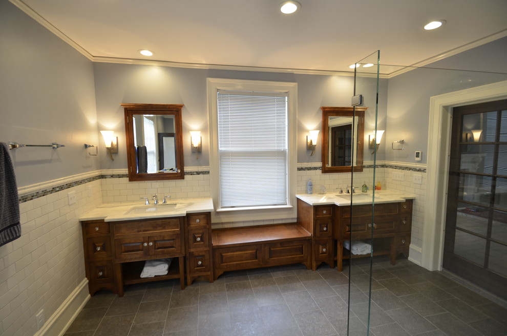 This is an example of a classic ensuite bathroom in Milwaukee with a submerged sink, freestanding cabinets, marble worktops, a corner shower, grey tiles, blue walls, slate flooring and medium wood cabinets.