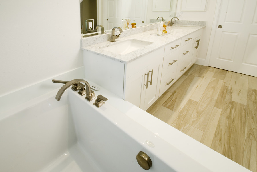 Example of a mid-sized minimalist master light wood floor bathroom design in Denver with quartzite countertops and white walls