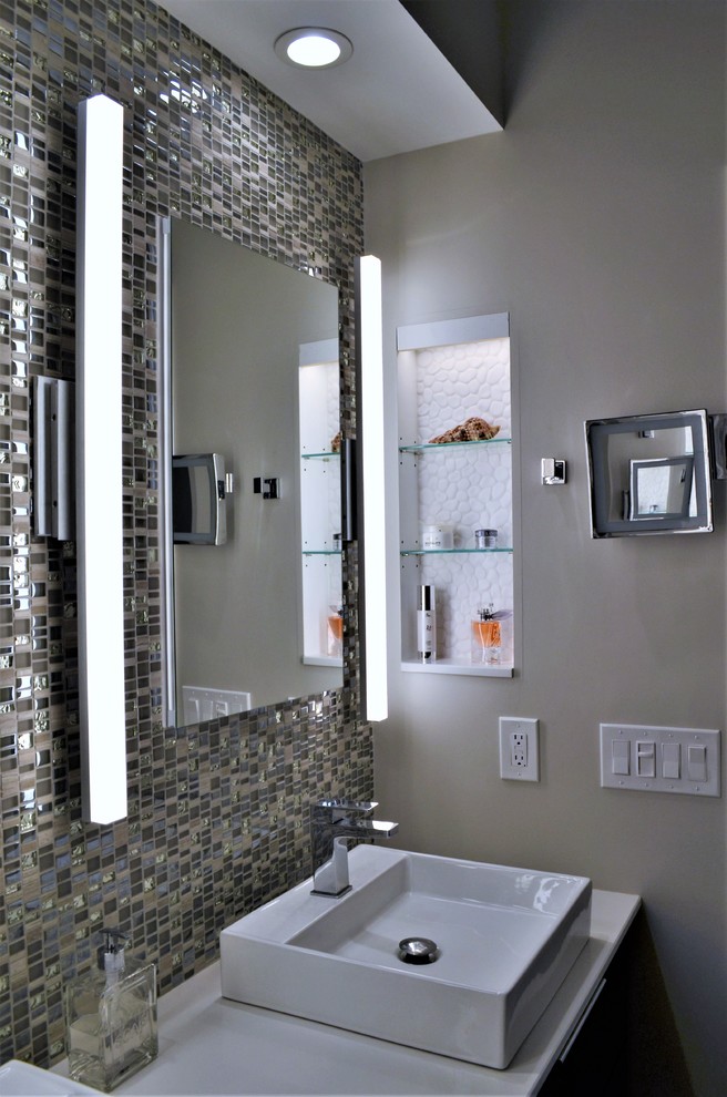 Example of a mid-sized minimalist master gray tile and porcelain tile porcelain tile and white floor bathroom design in Other with flat-panel cabinets, brown cabinets, a one-piece toilet, gray walls, a vessel sink, quartz countertops, a hinged shower door and white countertops