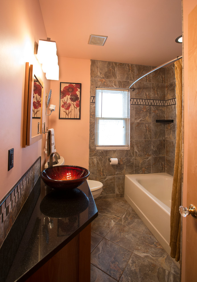 Tub/shower combo - small traditional master gray tile and ceramic tile ceramic tile tub/shower combo idea in Minneapolis with shaker cabinets, medium tone wood cabinets, beige walls, a vessel sink and quartzite countertops