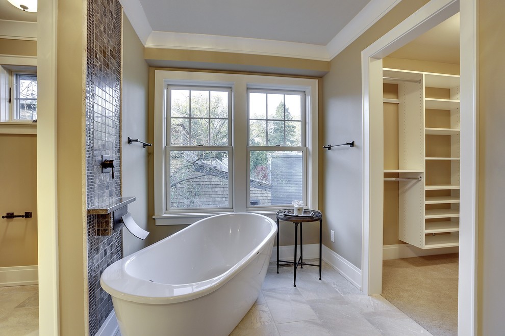 Large transitional master white tile and stone tile limestone floor bathroom photo in Minneapolis with an undermount sink, recessed-panel cabinets, white cabinets, marble countertops, a two-piece toilet and gray walls