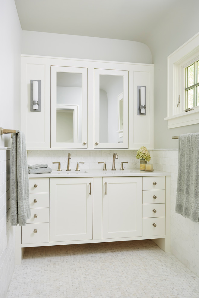 Inspiration for a mid-sized timeless master white tile and subway tile ceramic tile and white floor alcove shower remodel in Minneapolis with recessed-panel cabinets, white cabinets, a one-piece toilet, white walls, an undermount sink, quartzite countertops and a hinged shower door