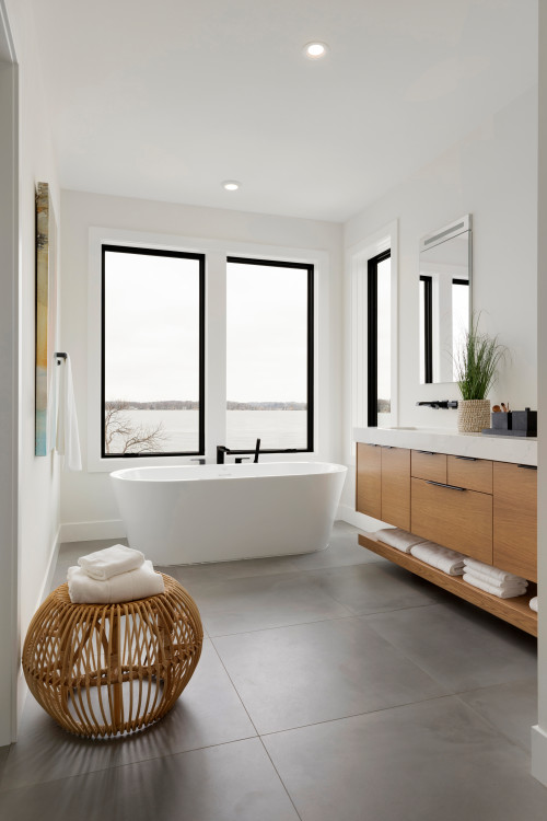 Symmetry and Style: White Freestanding Bathtub with Black Faucet - Concrete Floor Tiles Ideas