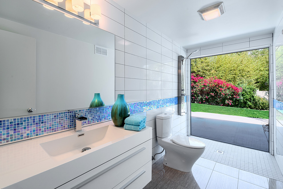Example of a minimalist bathroom design in Other with an integrated sink