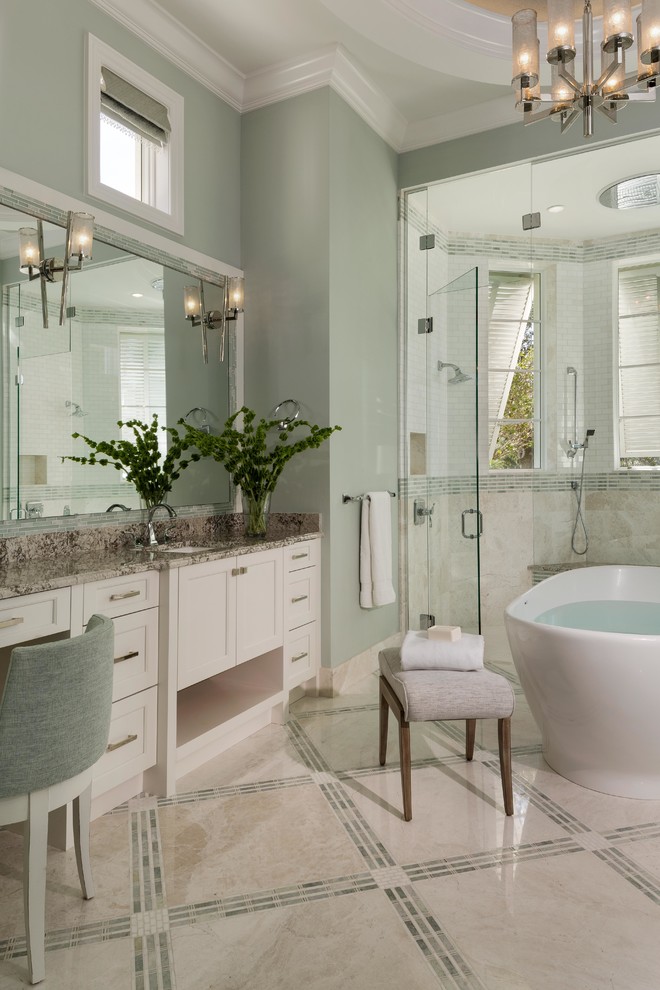 На фото: главная ванная комната в стиле неоклассика (современная классика) с отдельно стоящей ванной, разноцветным полом, фасадами в стиле шейкер, белыми фасадами, бежевой плиткой, врезной раковиной, душем с распашными дверями и зелеными стенами с