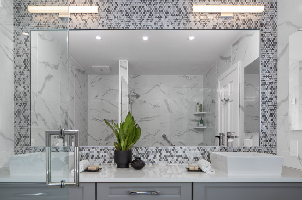 Example of a mid-sized trendy kids' white tile and porcelain tile plywood floor, white floor and double-sink bathroom design in Newark with recessed-panel cabinets, gray cabinets, quartz countertops, white countertops, a one-piece toilet, white walls, a vessel sink, a hinged shower door and a built-in vanity