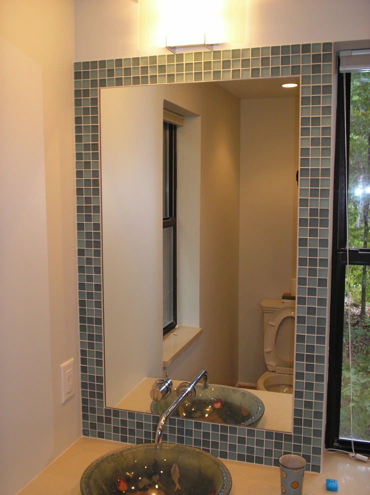 This is an example of a small beach style ensuite bathroom in Raleigh with a vessel sink, blue tiles, glass tiles and white walls.
