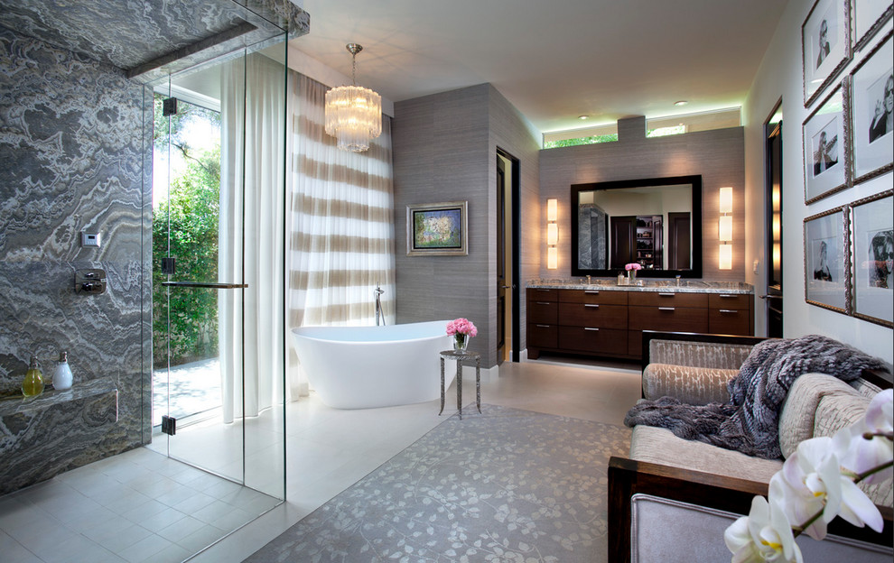 Photo of an expansive traditional ensuite bathroom in Salt Lake City with flat-panel cabinets, dark wood cabinets, a freestanding bath, a built-in shower, grey tiles, grey walls, porcelain flooring, a submerged sink and granite worktops.