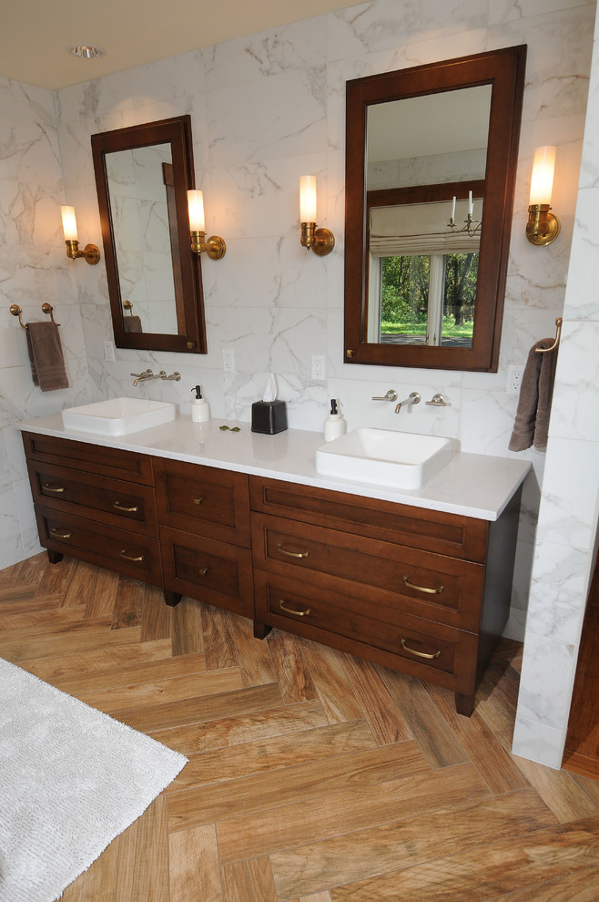 This is an example of a large traditional ensuite bathroom in Other with a vessel sink, recessed-panel cabinets, dark wood cabinets, marble worktops, a freestanding bath, white tiles, stone tiles, white walls and light hardwood flooring.