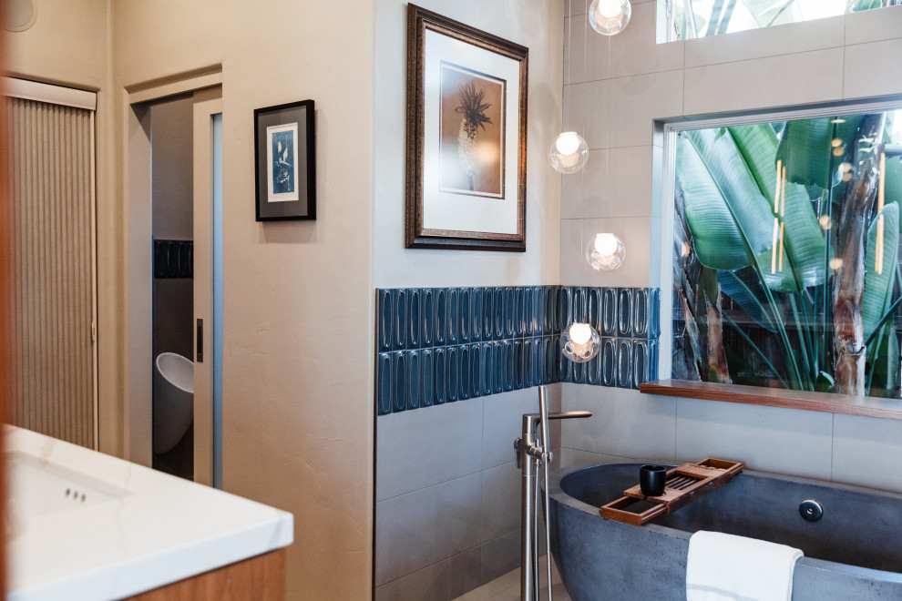 Mid-sized transitional master gray tile and porcelain tile porcelain tile and gray floor bathroom photo in San Diego with flat-panel cabinets, medium tone wood cabinets, a bidet, gray walls, an undermount sink, quartz countertops, a hinged shower door and white countertops