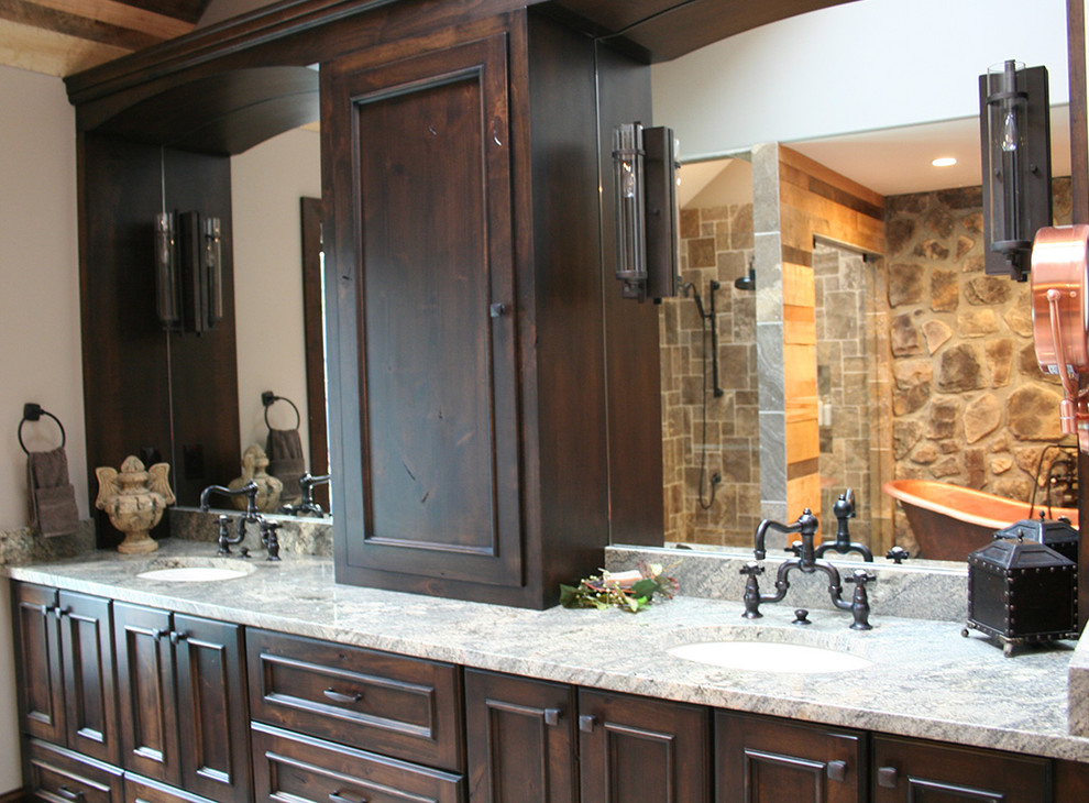 Example of a large tuscan master stone tile claw-foot bathtub design in Kansas City with granite countertops, beaded inset cabinets, dark wood cabinets, an urinal and white walls
