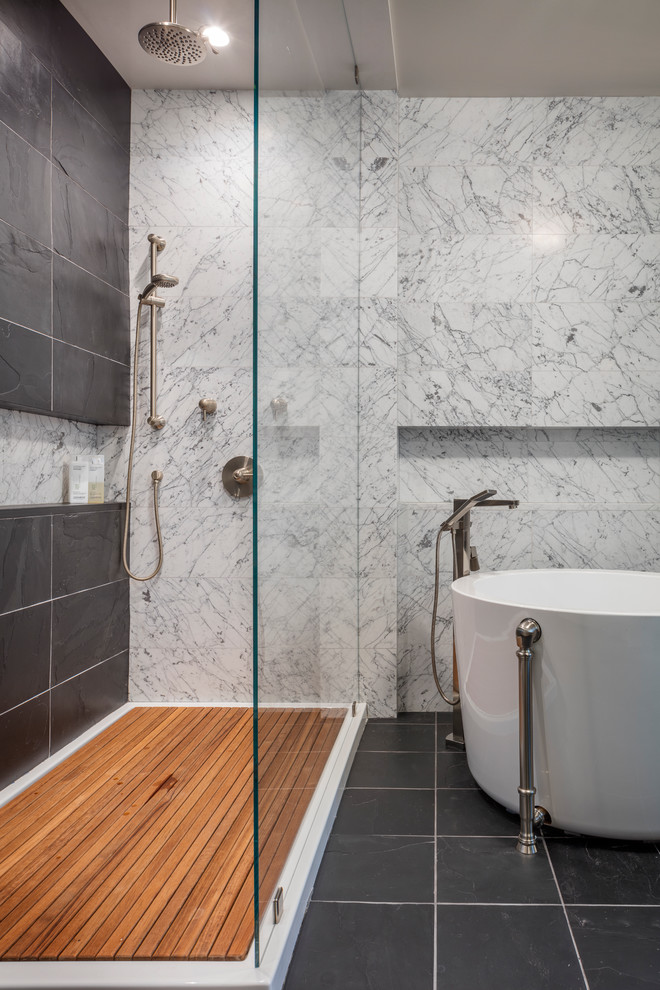 Design ideas for a medium sized traditional bathroom in Kansas City with flat-panel cabinets, medium wood cabinets, a japanese bath, a walk-in shower, a two-piece toilet, black tiles, stone tiles, blue walls, slate flooring, a vessel sink and marble worktops.