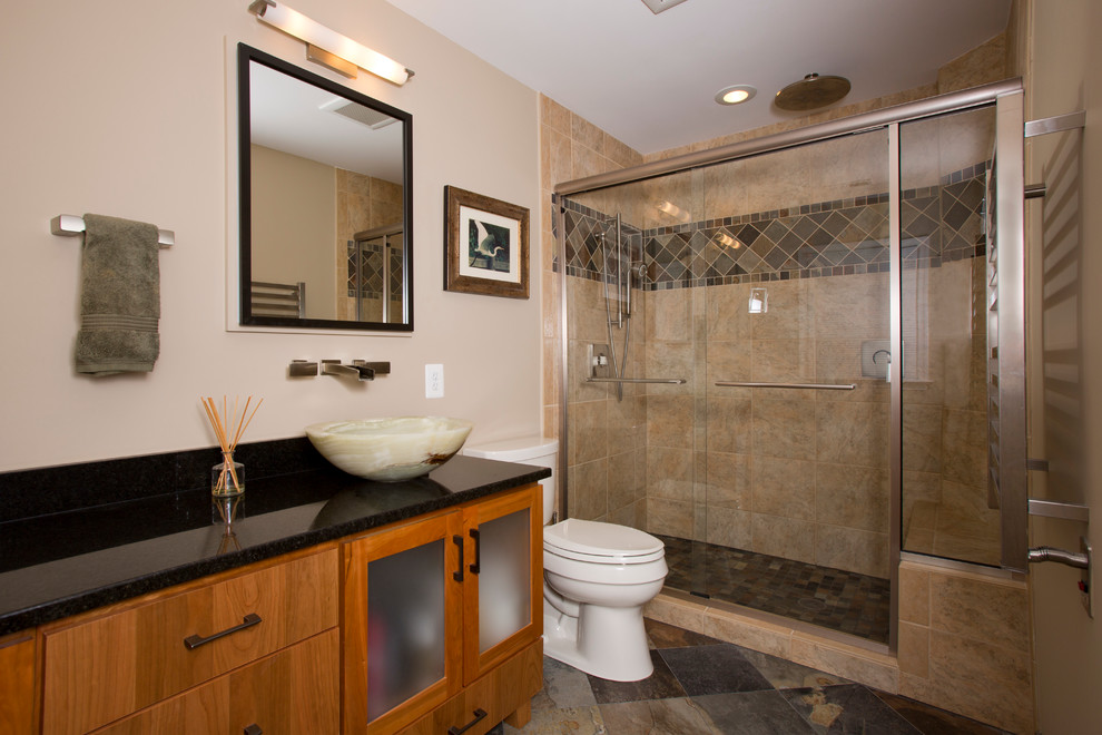 Example of a mid-sized arts and crafts master brown tile slate floor alcove shower design in DC Metro with a vessel sink, flat-panel cabinets, granite countertops, beige walls, a two-piece toilet and medium tone wood cabinets