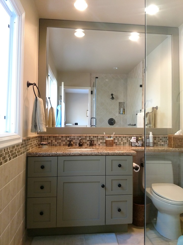 This is an example of a classic bathroom in Orange County with shaker cabinets and green cabinets.