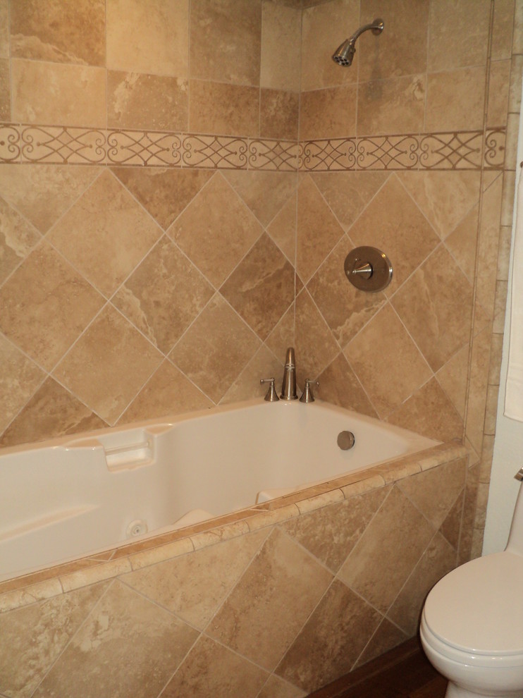 Inspiration for a mid-sized timeless master beige tile and porcelain tile medium tone wood floor bathroom remodel in Orange County with an undermount sink, raised-panel cabinets, medium tone wood cabinets, granite countertops, a two-piece toilet and beige walls