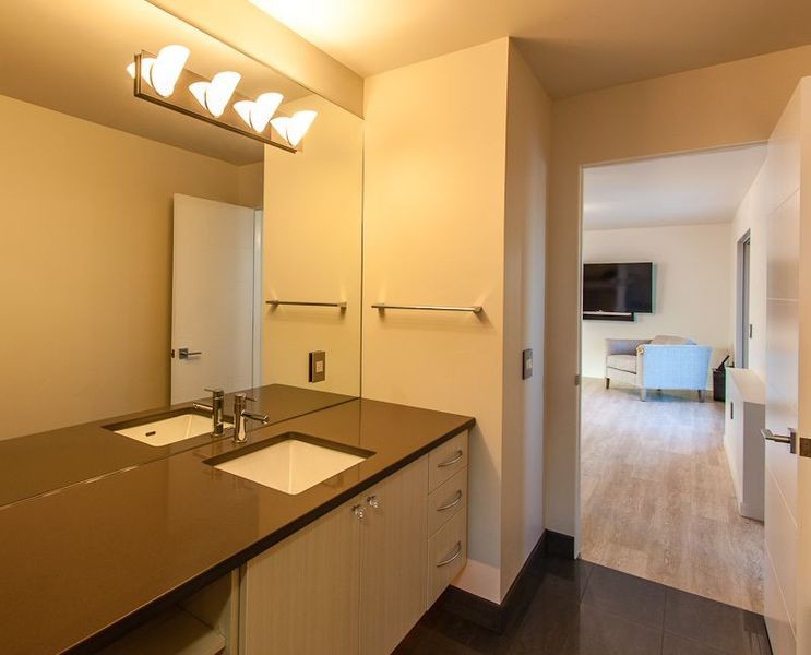 Cette photo montre une salle de bain moderne de taille moyenne avec un lavabo encastré, un placard à porte plane et un plan de toilette en quartz modifié.