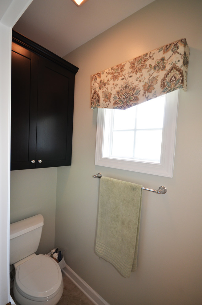 Photo of a medium sized classic ensuite bathroom in Charlotte with a submerged sink, shaker cabinets, brown cabinets, engineered stone worktops, a built-in bath, a two-piece toilet, beige tiles, porcelain tiles and porcelain flooring.