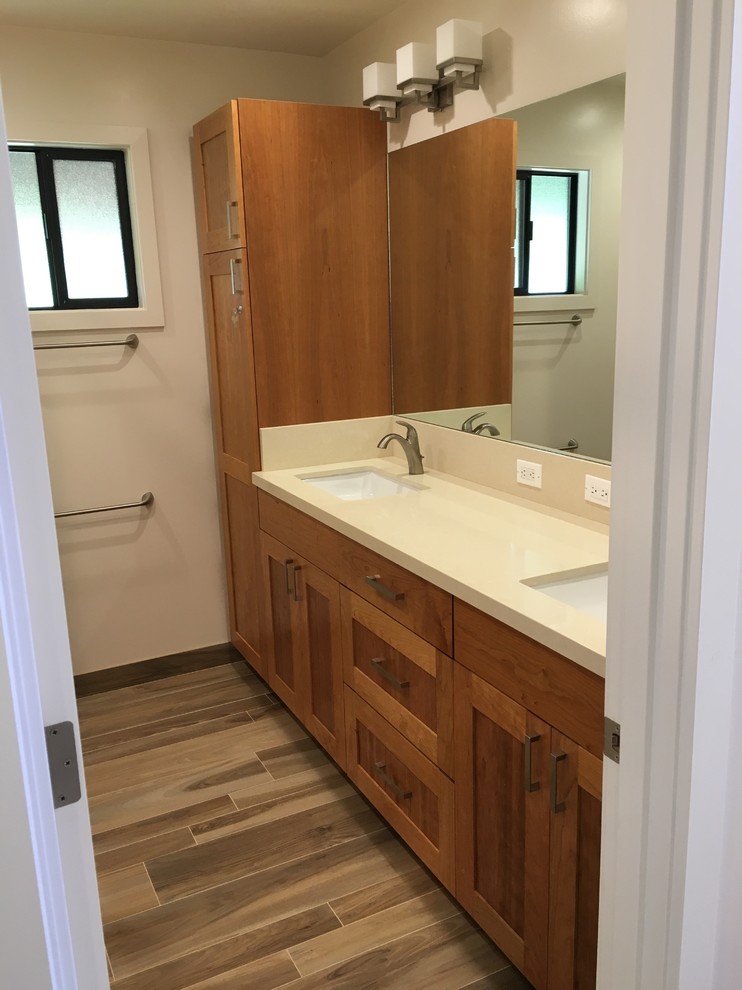 Medium sized nautical ensuite bathroom in Hawaii with shaker cabinets, dark wood cabinets, a freestanding bath, a walk-in shower, a wall mounted toilet, beige tiles, porcelain tiles, white walls, porcelain flooring, a submerged sink, quartz worktops, brown floors and an open shower.